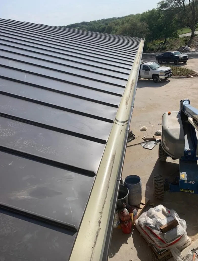 Standing seam panel and gutter detail on a metal roofing jobsite in East Greenbush